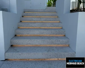 Concrete stairs with wooden steps leading to a doorway