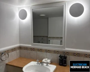 Modern bathroom with a clean white sink, mirror, and tile accents.